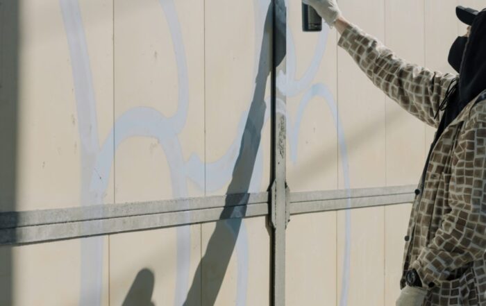 A man spray painting a wall